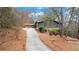 Exterior view of a single-Gathering home with a long driveway surrounded by trees and landscaping at 4230 N Elizabeth Se Ln, Atlanta, GA 30339