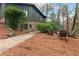 Exterior side view of a stone and wooden house, with walkway and chairs at 4230 N Elizabeth Se Ln, Atlanta, GA 30339