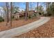 A home featuring a stone facade and a long, winding driveway surrounded by trees at 4230 N Elizabeth Se Ln, Atlanta, GA 30339