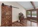 Foyer with a wood sliding barn door, stylish cabinet, and hardwood floors at 4230 N Elizabeth Se Ln, Atlanta, GA 30339