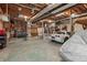 Spacious garage with an open ceiling, tool chests, a sink, and a white sports car at 4230 N Elizabeth Se Ln, Atlanta, GA 30339