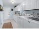 Well-lit laundry room featuring modern washer and dryer, white cabinetry, and light blue wall paint at 4230 N Elizabeth Se Ln, Atlanta, GA 30339