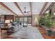 Open-concept living room with exposed beams, hardwood floors, and a stone fireplace at 4230 N Elizabeth Se Ln, Atlanta, GA 30339