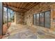 Outdoor patio with unique stone flooring and a stone wall and a wooden porch swing at 4230 N Elizabeth Se Ln, Atlanta, GA 30339