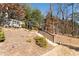 Landscaped backyard featuring a stone staircase leading to a charming white swing at 515 Windy Ridge Ct, Canton, GA 30114