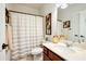 Bathroom with a wood vanity, a tub-shower combination, and decorative accents at 515 Windy Ridge Ct, Canton, GA 30114