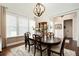 Formal dining room featuring an elegant chandelier and large windows for natural light at 515 Windy Ridge Ct, Canton, GA 30114