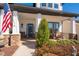 Inviting front porch with stone accents and an American flag at 515 Windy Ridge Ct, Canton, GA 30114