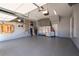 Spacious garage with epoxy floors, stainless steel cabinets, and overhead storage racks at 515 Windy Ridge Ct, Canton, GA 30114