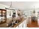 Kitchen with stainless steel sink in the island and breakfast bar overlooking the living room at 515 Windy Ridge Ct, Canton, GA 30114