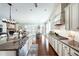 Large kitchen open to living and dining area, featuring stone fireplace and modern appliances at 515 Windy Ridge Ct, Canton, GA 30114