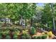 Beautiful, landscaped front yard with lush greenery, garden swing and rock features at 515 Windy Ridge Ct, Canton, GA 30114