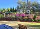 Beautiful landscaping with mature trees, flowering bushes, and a swing at 515 Windy Ridge Ct, Canton, GA 30114