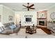 Cozy living room with stone fireplace and view to hall and other spaces at 515 Windy Ridge Ct, Canton, GA 30114