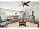 Open-concept living room with sofas, hardwood floors, and seamless flow to the modern kitchen and dining area at 515 Windy Ridge Ct, Canton, GA 30114