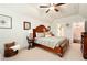 Spacious bedroom with a wooden bed frame, vaulted ceiling, and carpet flooring at 515 Windy Ridge Ct, Canton, GA 30114