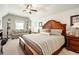 Bedroom with a king bed, sitting area with a couch, ceiling fan, and natural light from the window at 515 Windy Ridge Ct, Canton, GA 30114