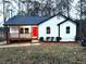 Charming single-story home featuring a cozy front porch and a vibrant red front door at 5729 Rock Rd, Union City, GA 30291