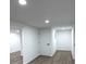 Bright hallway leads to various rooms featuring modern floors and neutral walls at 5729 Rock Rd, Union City, GA 30291