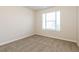 This carpeted bedroom is bright with a large window providing natural light at 8542 Lakemeadow Dr, Union City, GA 30291