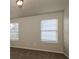 A bedroom is naturally lit through its two, large, shuttered windows at 8542 Lakemeadow Dr, Union City, GA 30291