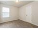 This carpeted bedroom is bright with a large window and a white door at 8542 Lakemeadow Dr, Union City, GA 30291