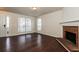 Inviting living room featuring dark hardwood floors and a brick fireplace at 8542 Lakemeadow Dr, Union City, GA 30291