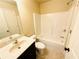 Bathroom featuring tile floor, single sink vanity, toilet and shower-tub combo at 2378 Misty Ivy Ct, Buford, GA 30519