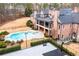 Aerial view of a brick home with a basketball court, pool, and lush green backyard at 3201 Hobsons Ridge Nw Trl, Acworth, GA 30101