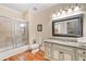 Granite vanity bathroom with a tiled shower and view of the water closet at 3201 Hobsons Ridge Nw Trl, Acworth, GA 30101