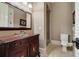 Charming bathroom with a unique vanity, framed mirror, tiled floor, shower, and toilet at 3201 Hobsons Ridge Nw Trl, Acworth, GA 30101