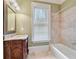 Elegant bathroom with a carved wood vanity, marble countertops, and a tiled shower/tub at 3201 Hobsons Ridge Nw Trl, Acworth, GA 30101