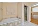 A relaxing bath area with a soaking tub and glass enclosed shower at 3201 Hobsons Ridge Nw Trl, Acworth, GA 30101