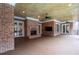 Covered patio with a brick fireplace and wood-planked ceiling, perfect for outdoor entertaining at 3201 Hobsons Ridge Nw Trl, Acworth, GA 30101