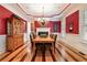 Formal dining room with decorative ceiling, hardwood floors, and bright red walls at 3201 Hobsons Ridge Nw Trl, Acworth, GA 30101