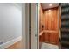 Interior view of a wood paneled elevator with a black folding safety gate at 3201 Hobsons Ridge Nw Trl, Acworth, GA 30101