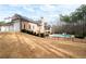 Backyard view of a brick home, pool, and spacious yard including a basketball court and swing set at 3201 Hobsons Ridge Nw Trl, Acworth, GA 30101