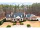 Stately brick home with a classic design, surrounded by lush greenery and mature trees at 3201 Hobsons Ridge Nw Trl, Acworth, GA 30101