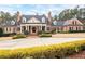 Elegant brick home featuring manicured landscaping and a circular driveway, exuding curb appeal at 3201 Hobsons Ridge Nw Trl, Acworth, GA 30101