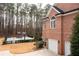 Brick exterior of home with basketball court, three-car garage, mature landscaping, and a backyard at 3201 Hobsons Ridge Nw Trl, Acworth, GA 30101