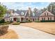 Impressive brick home with manicured lawn, circular driveway, and classic architectural details at 3201 Hobsons Ridge Nw Trl, Acworth, GA 30101
