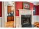 Ornate white fireplace with dark stone surround and access to a butler's pantry at 3201 Hobsons Ridge Nw Trl, Acworth, GA 30101