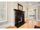 Close-up of fireplace with dark wood mantel and access to French doors at 3201 Hobsons Ridge Nw Trl, Acworth, GA 30101