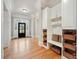 Inviting foyer featuring built-in storage, hardwood floors, and a view of the front door at 3201 Hobsons Ridge Nw Trl, Acworth, GA 30101