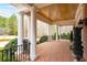 Inviting front porch featuring brick flooring, elegant columns, and scenic views at 3201 Hobsons Ridge Nw Trl, Acworth, GA 30101