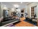 Bright home gym with a variety of modern workout equipment, hardwood floors, and a fireplace with a TV above at 3201 Hobsons Ridge Nw Trl, Acworth, GA 30101
