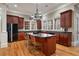 Stylish kitchen with dark cabinetry, granite countertops, an island with seating, and a stainless steel fridge at 3201 Hobsons Ridge Nw Trl, Acworth, GA 30101