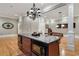 Kitchen island featuring dark wood cabinets, a granite countertop, and modern stainless steel appliances at 3201 Hobsons Ridge Nw Trl, Acworth, GA 30101