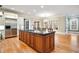 Gourmet kitchen featuring a central island, stainless steel refrigerator, and bright windows at 3201 Hobsons Ridge Nw Trl, Acworth, GA 30101