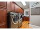 Well-organized laundry room with modern washer and dryer, ample cabinet space, and stylish finishes at 3201 Hobsons Ridge Nw Trl, Acworth, GA 30101